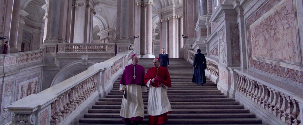 (L to R) Brían F. O'Byrne as Cardinal O'Malley and Ralph Fiennes as Cardinal Lawrence in director Edward Berger's CONCLAVE, a Focus Features release. Credit: Courtesy of Focus Features. © 2024 All Rights Reserved.